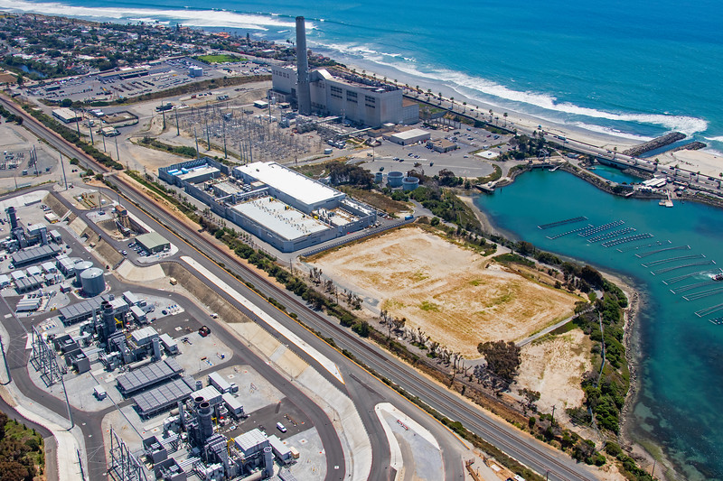 An aerial view of the North County coastline and the Carlsbad Desalination Plant with Interstate-5 in the foreground.